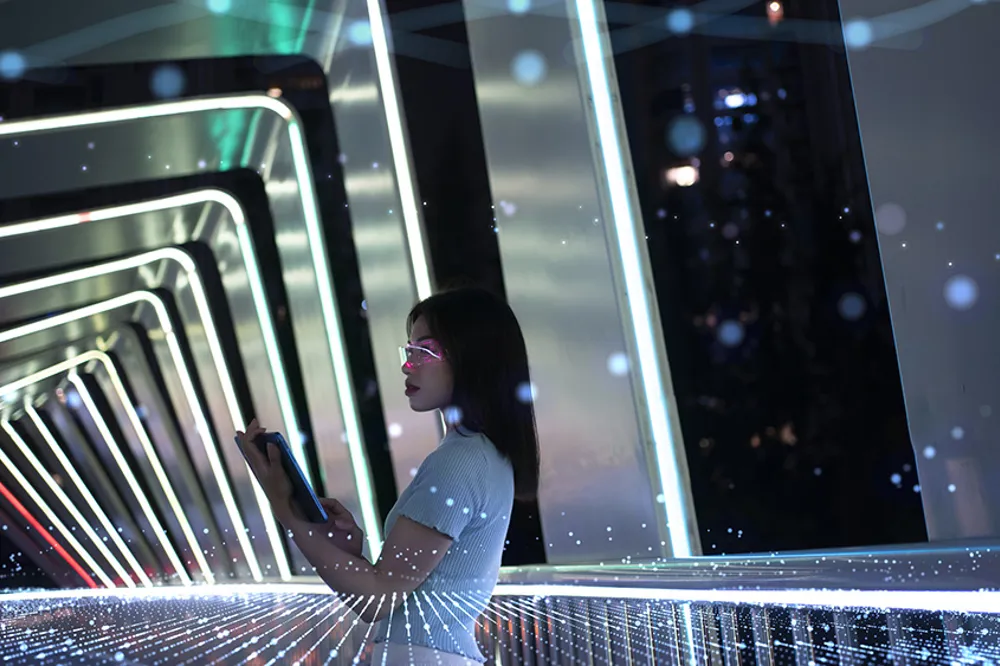 ALT Text: a Artificial Reality tunnel with a woman in the middle working on a tablet 